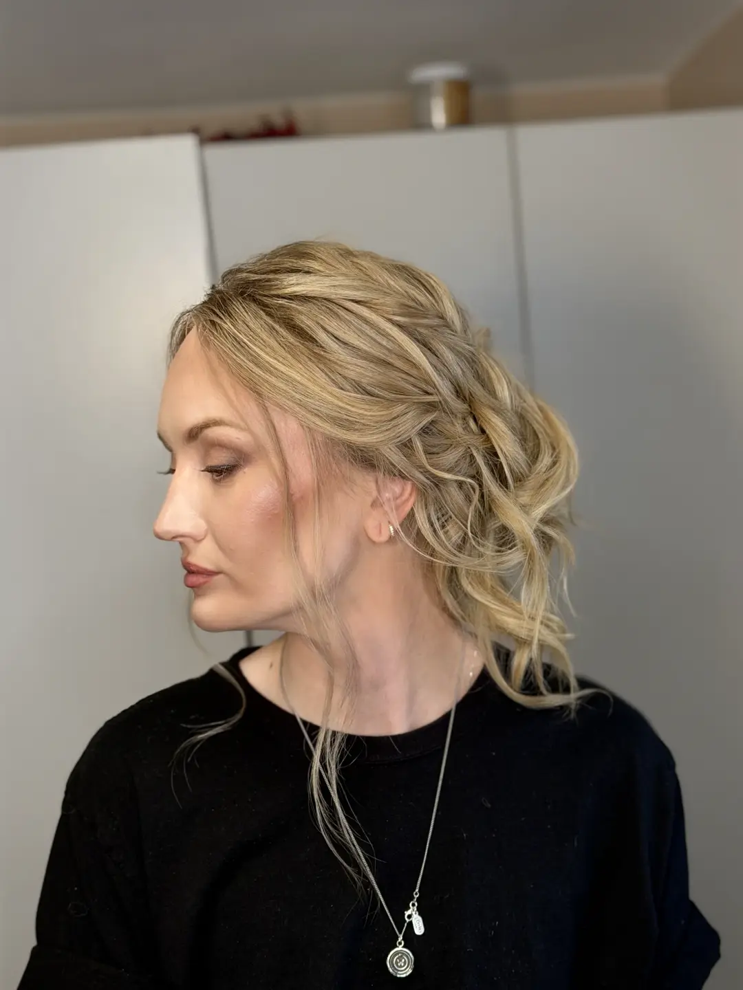 Blonde textured low updo with soft face-framing strands