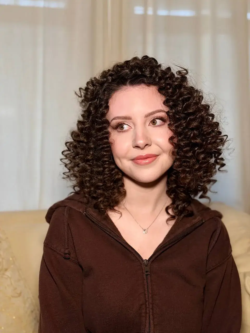 Brunette with defined shoulder-length corkscrew curls